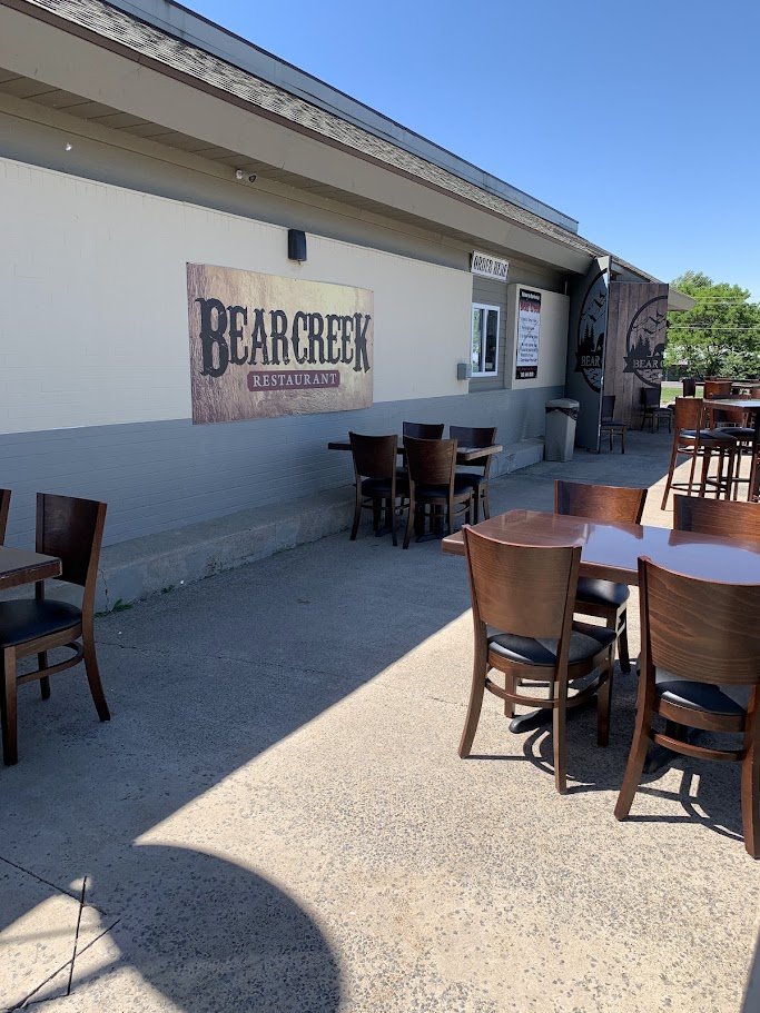 Restaurant exterior with roadside parking and entrance.