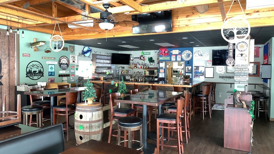 A local restaurant space with tables and a bar.